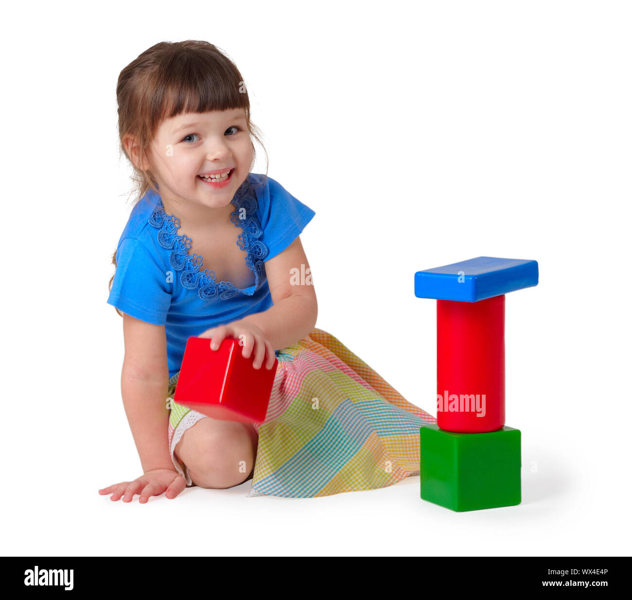Girl playing with toys on a white background Stock Photo - Alamy