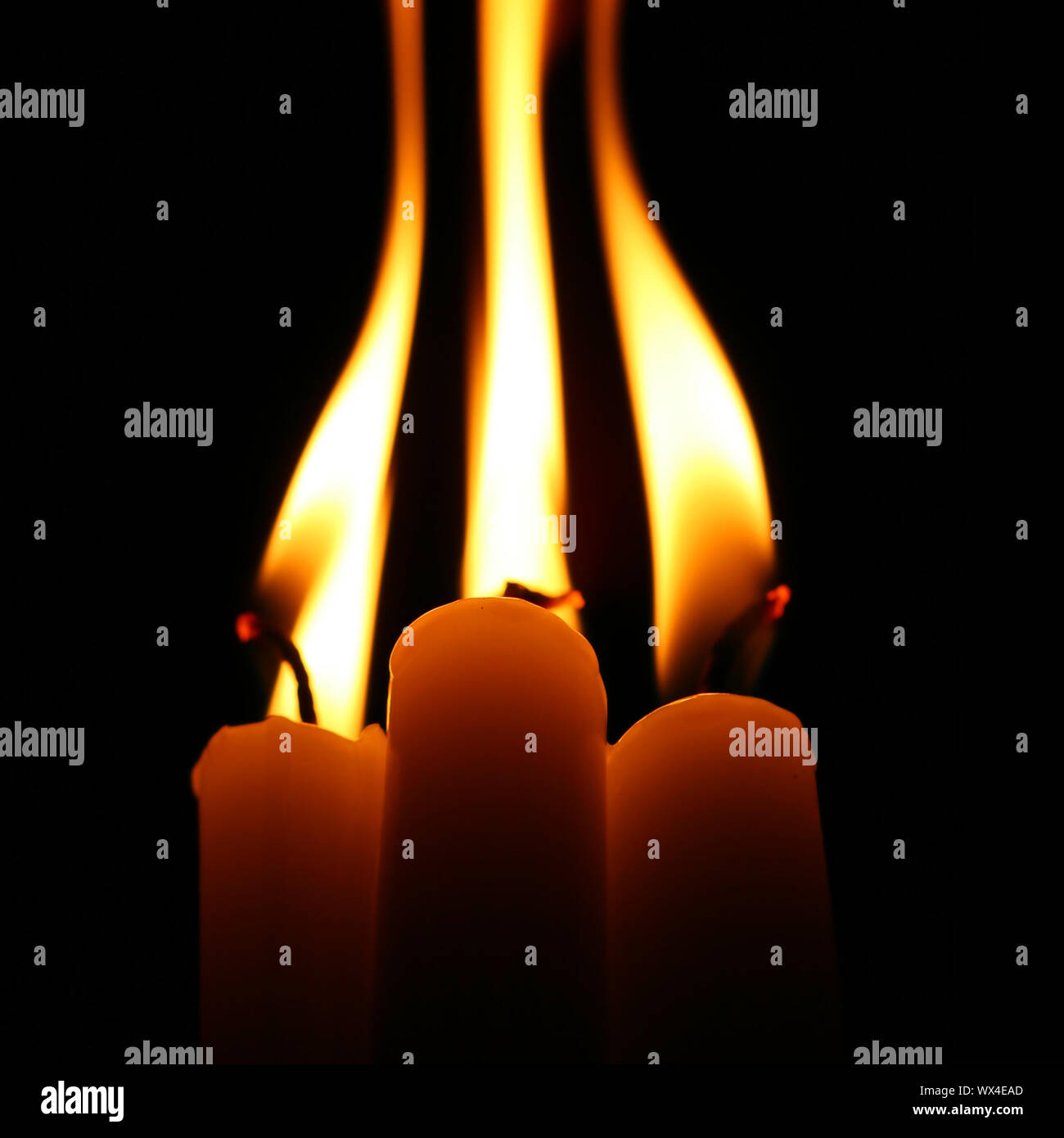 sacred candles in dark on black background Stock Photo Alamy