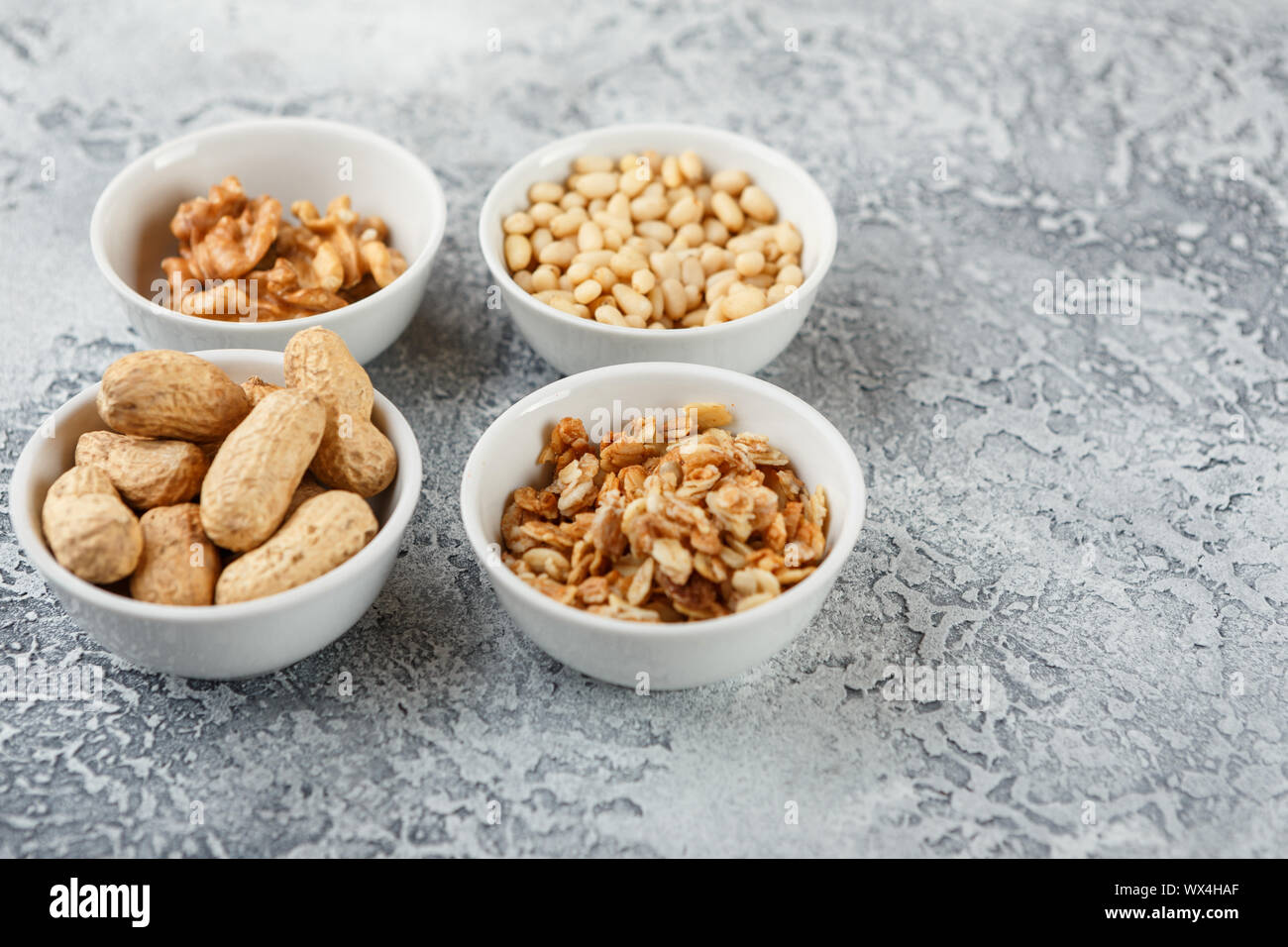 Different nuts on gray background Stock Photo