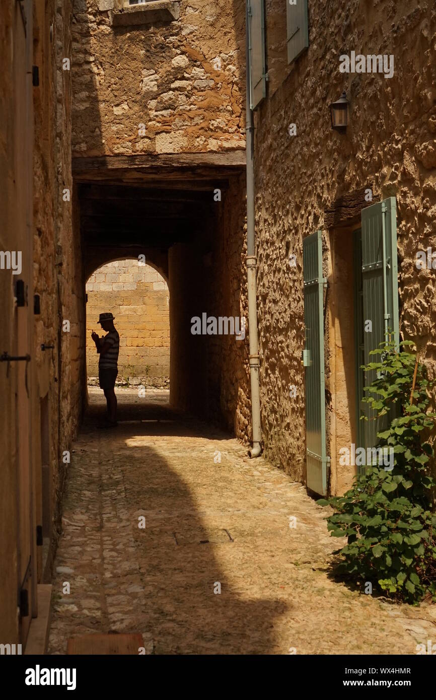 A silhouette of a man in the distance through a rural French tunnel Stock Photo