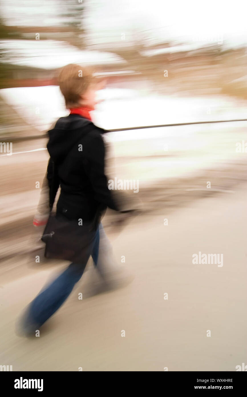 A motion blur abstract of a person walking in a hurry, a late rushing ...