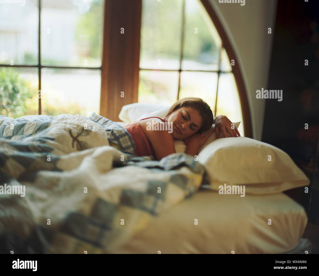 Mid-adult woman sleeping in a bed Stock Photo - Alamy