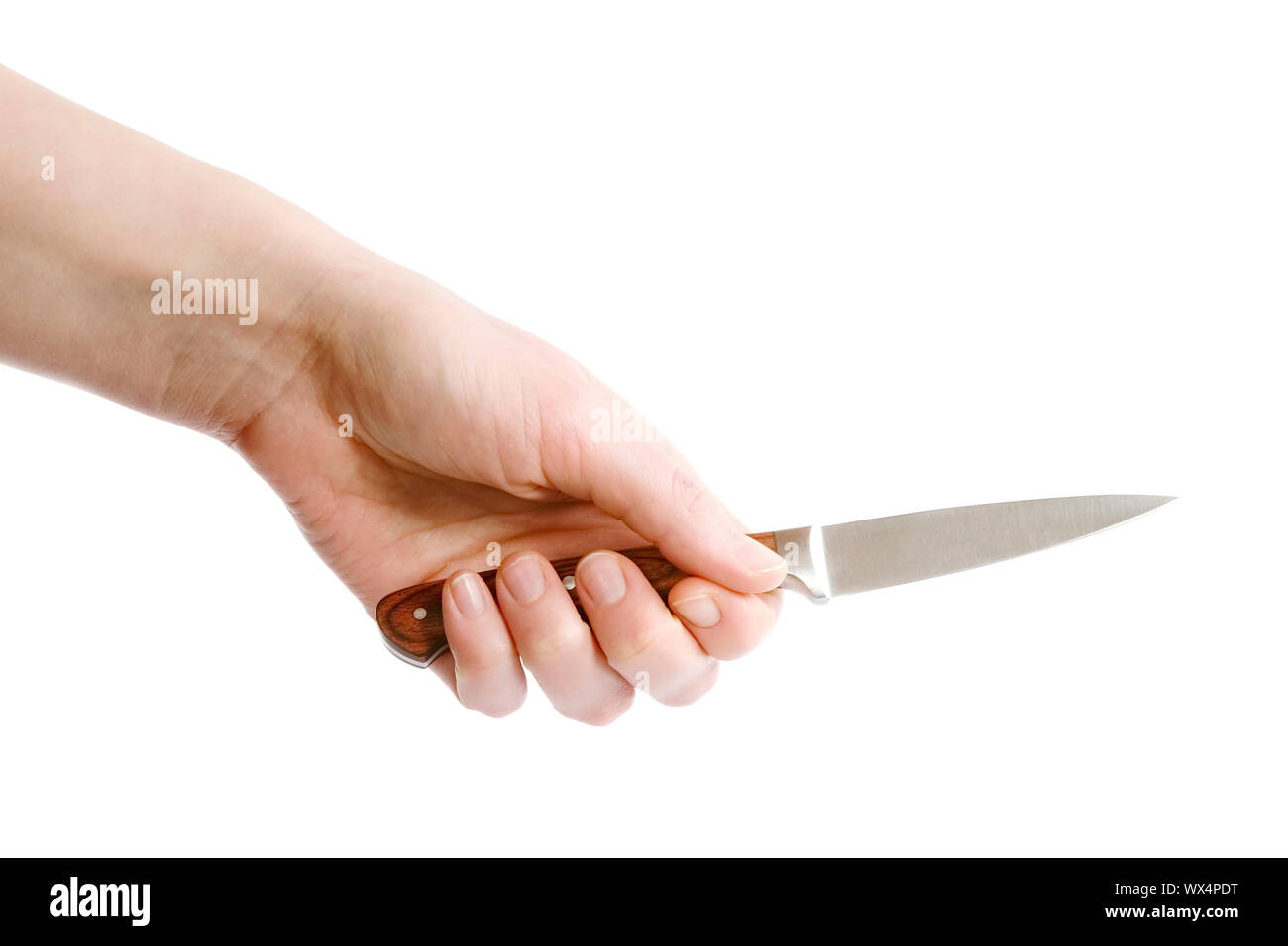 A small pearing knife in a female hand, ready to cut something.  Isolated on white with clipping path. Stock Photo