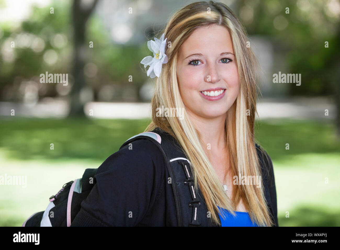 Close-up portrait of a cute teenage girl holding backpack Stock Photo ...