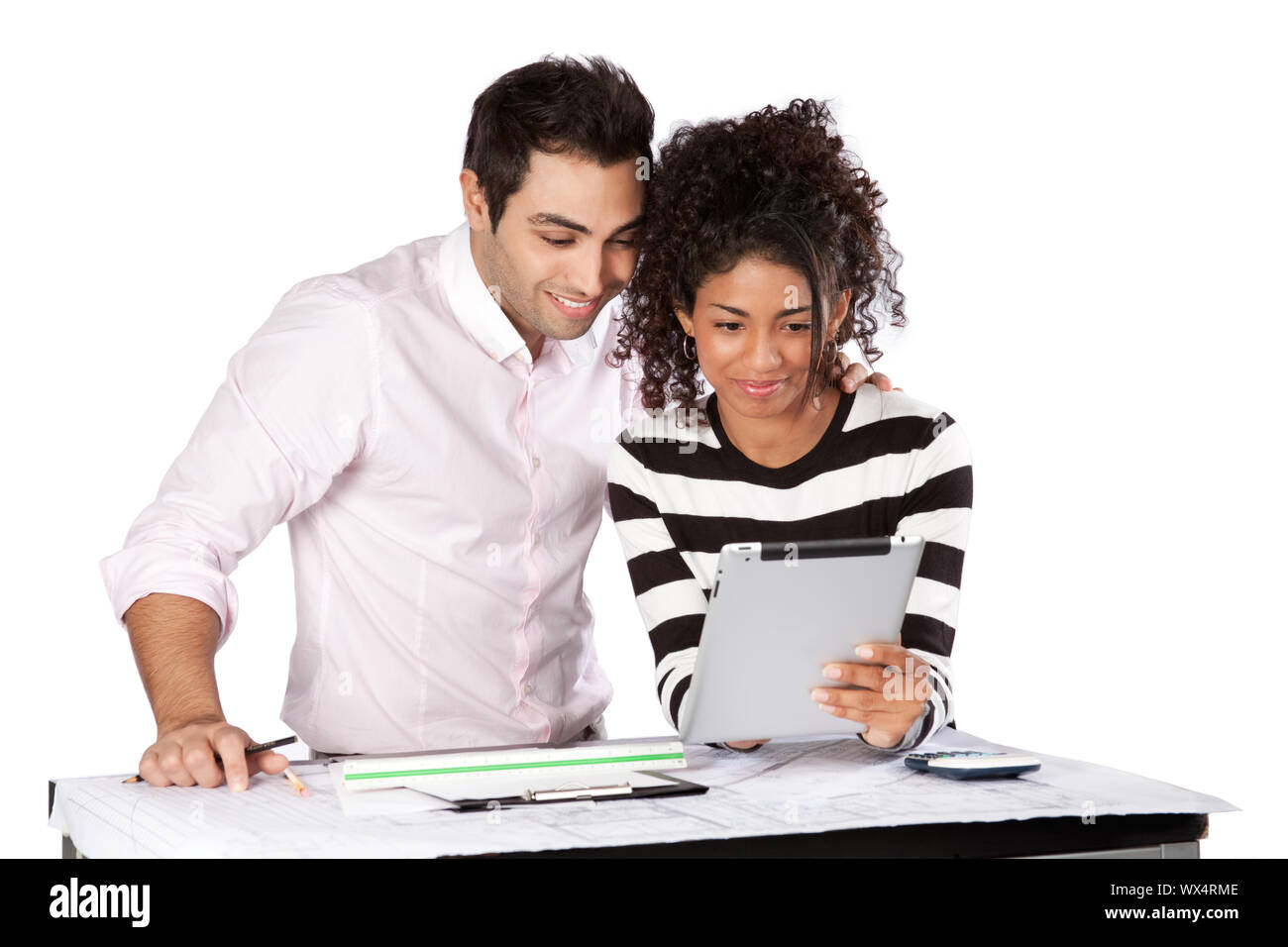 Two architects using digital tablet at work isolated on white background. Stock Photo
