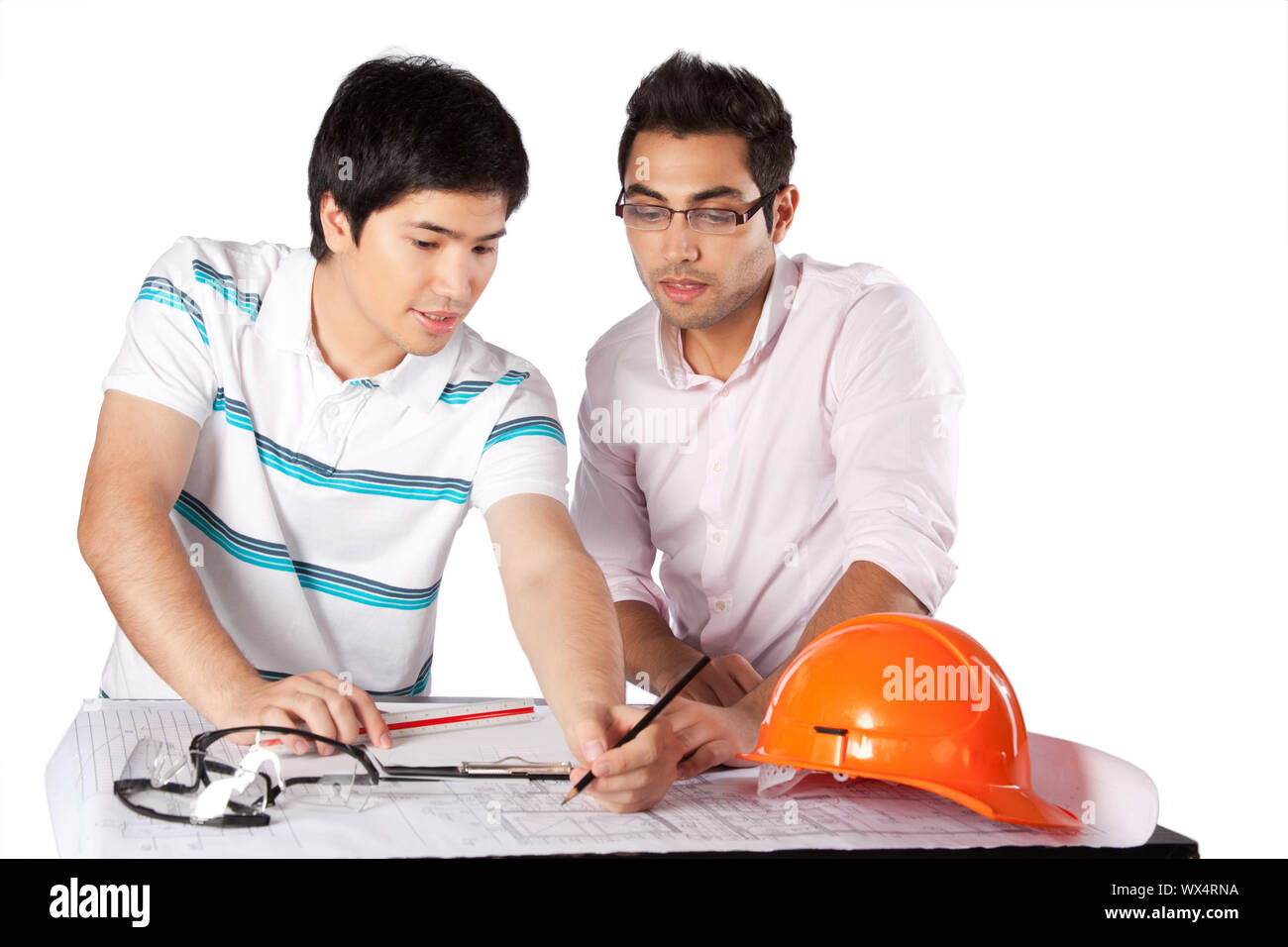 Two architects discussing on blueprints isolated on white background. Stock Photo