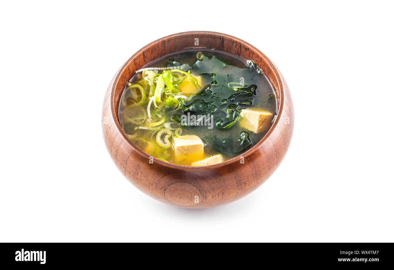 Miso soup japanese traditional meal in wooden bowl isolated on white background Stock Photo