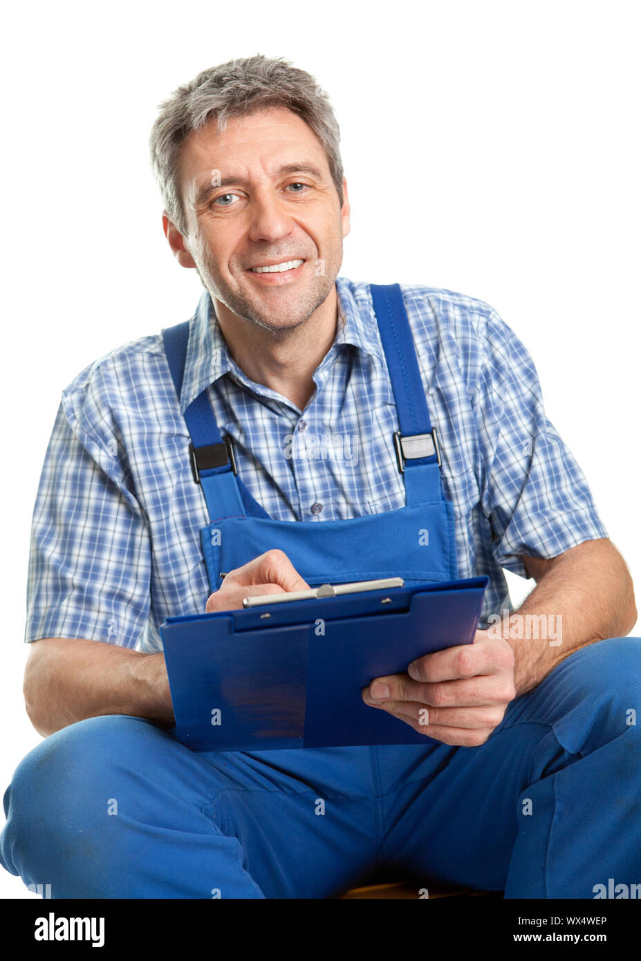 Confident service man taking notes. Isolated on white Stock Photo