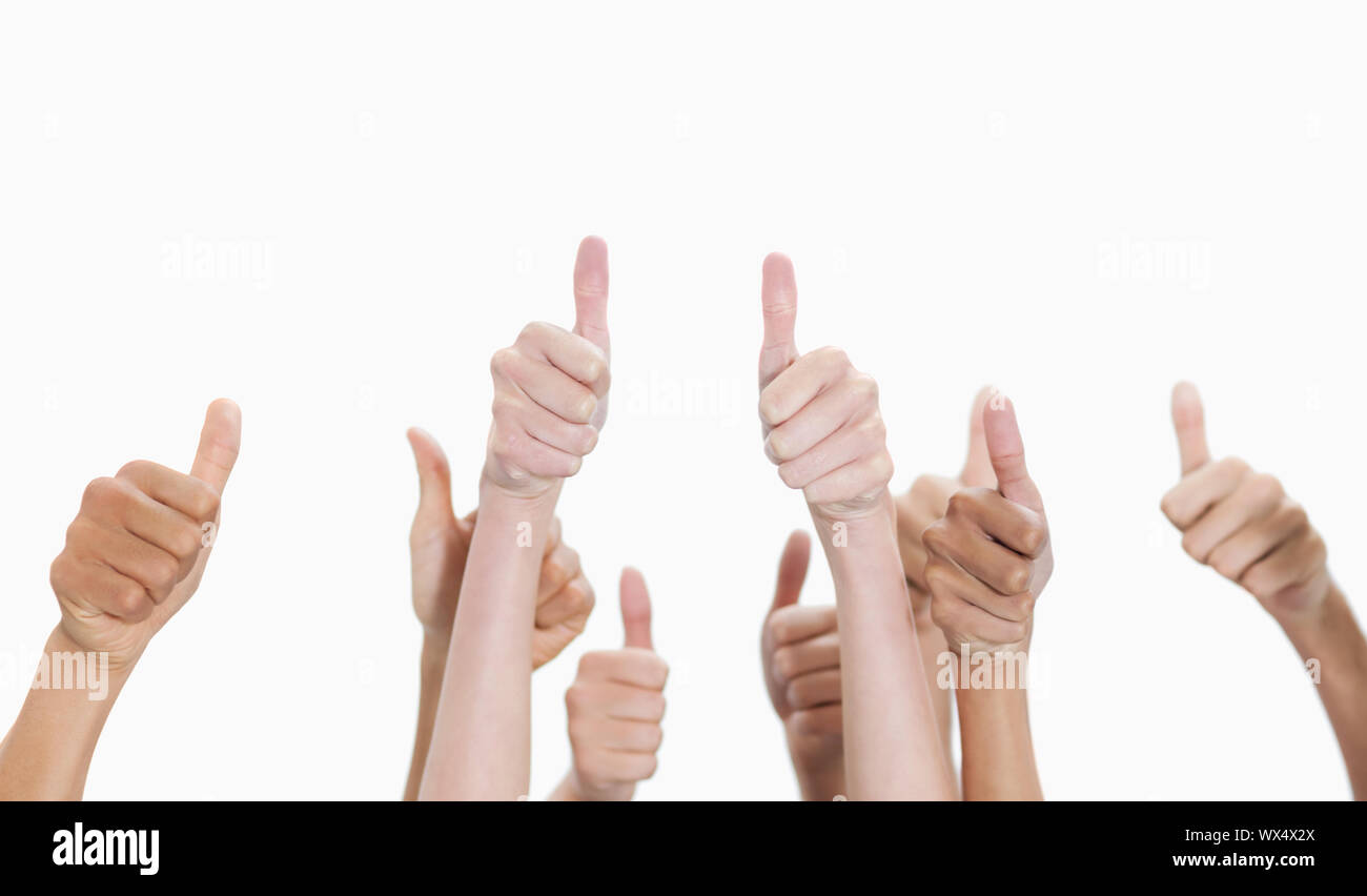 Thumbs-up against white background Stock Photo - Alamy