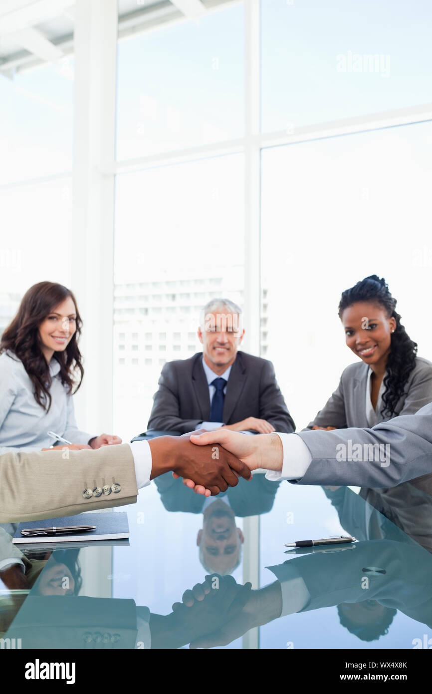 Friendly handshake between two colleagues during a meeting Stock Photo