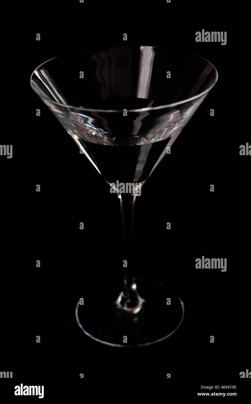 Cocktail glass against a black background Stock Photo - Alamy