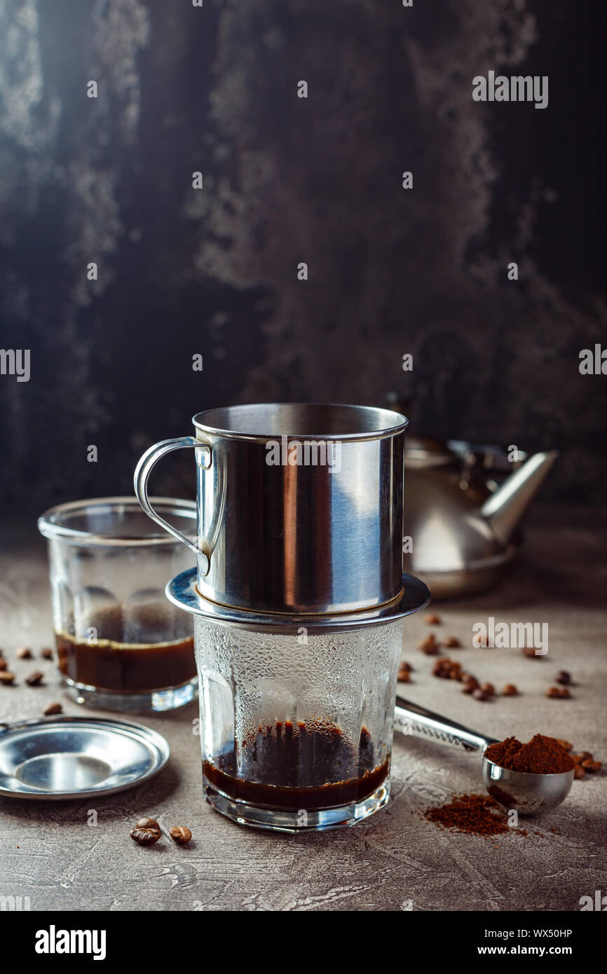 Vietnamese coffee in glass cups and traditional metal coffee maker phin.  Traditional method of making of vietnamese coffee Stock Photo - Alamy