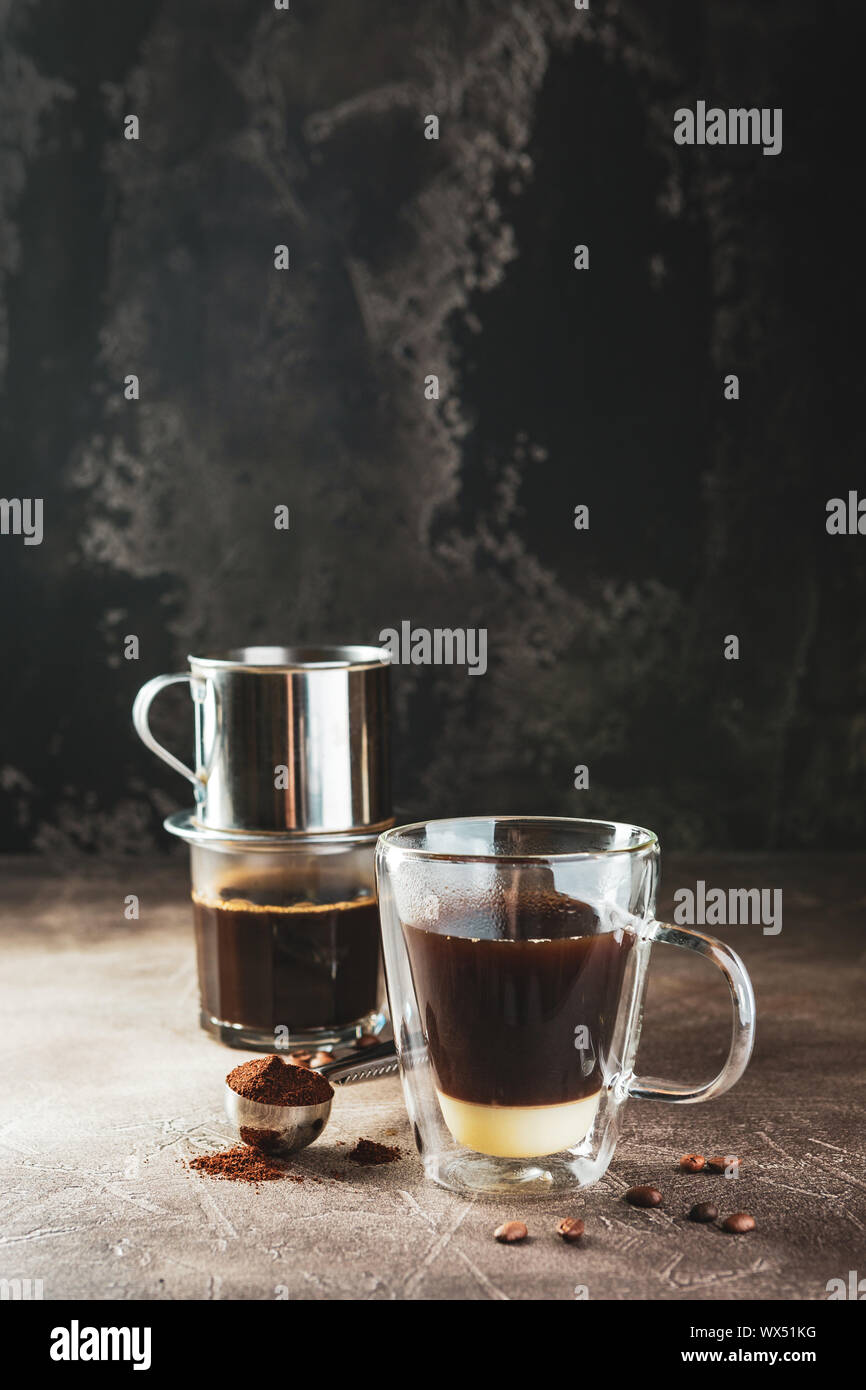 Vietnamese coffee with condensed milk in glass cups and traditional