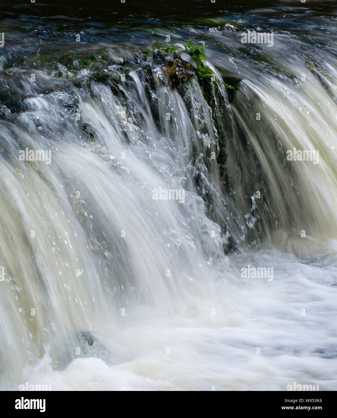 Multiple exposure of a short waterfall . weir on the river Plym. Stock Photo