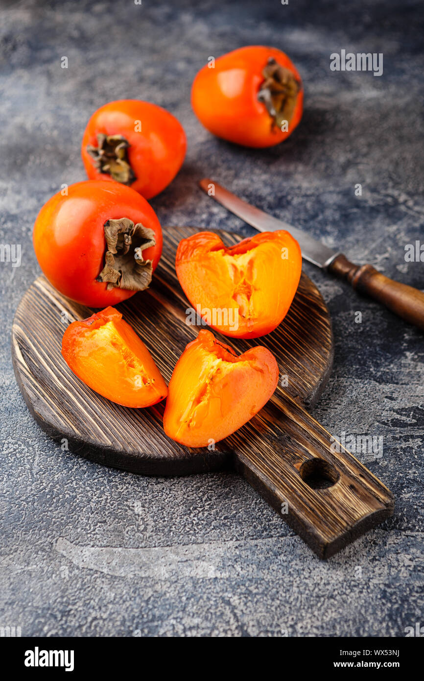 Ripe persimmon fruit on dark Stock Photo