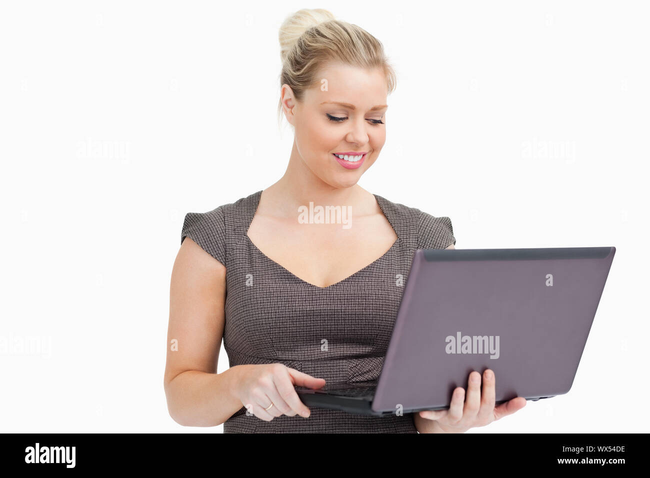 Woman browsing on a laptop against white background Stock Photo - Alamy