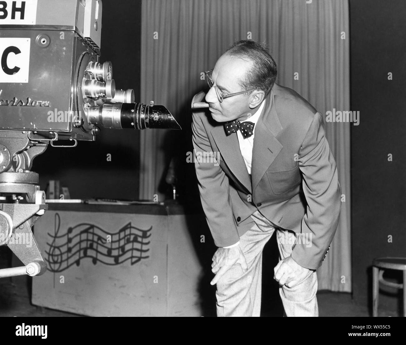 GROUCHO MARX circa 1955 Candid with TV Camera Publicity for TV Series YOU BET YOUR LIFE NBC / National Broadcasting Corporation Stock Photo