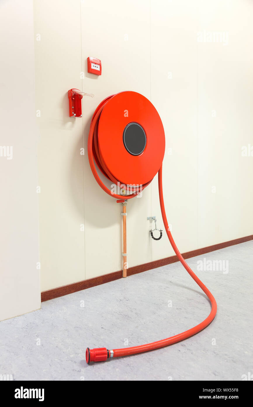 Fire hose in building for fire fighting Stock Photo
