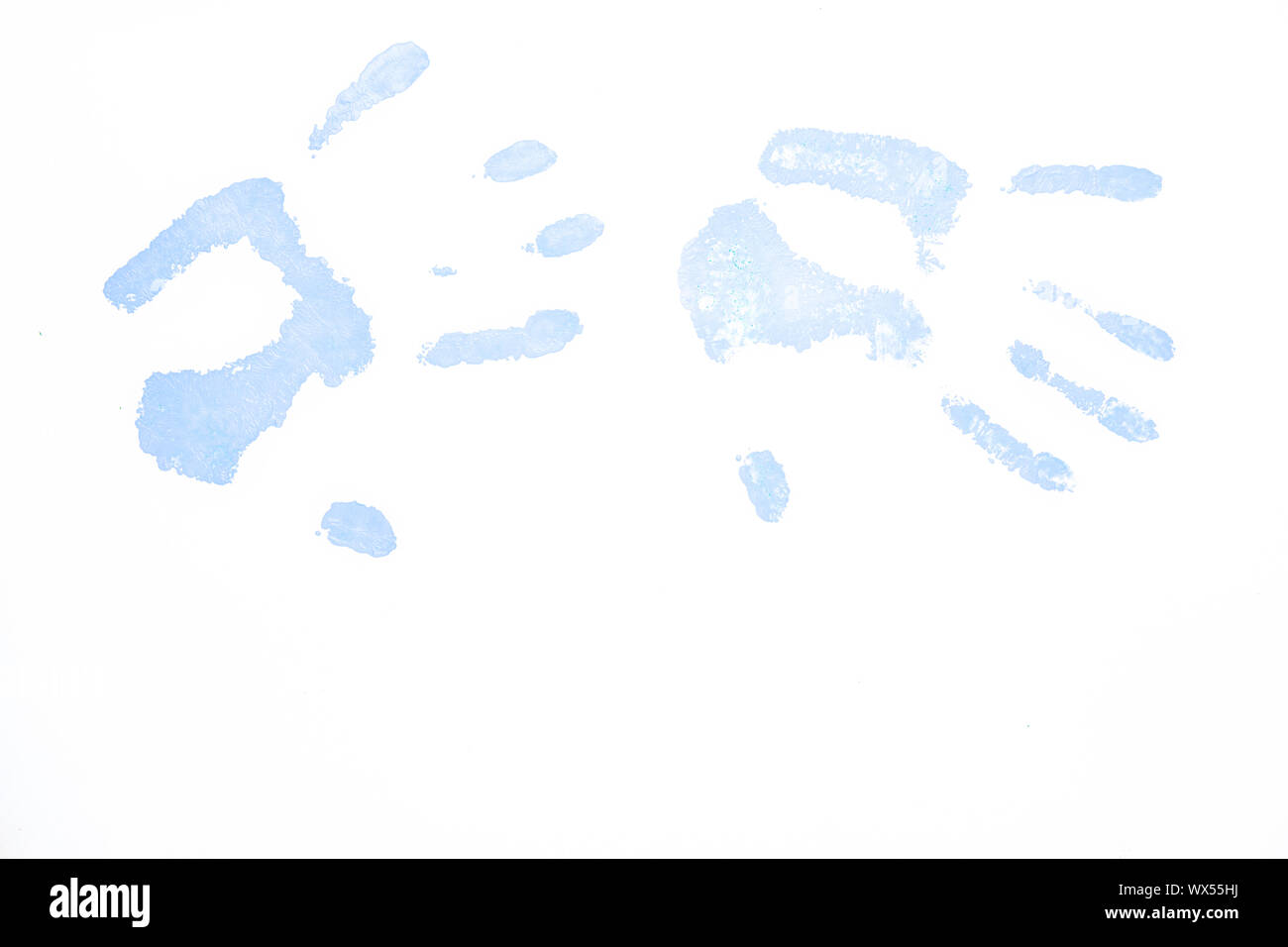 Two blue handprints against a white background Stock Photo - Alamy