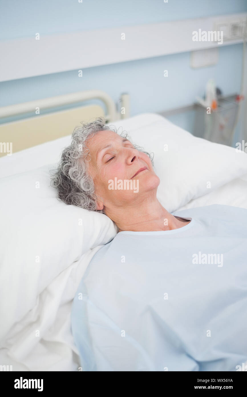 Patient sleeping on a bed in hospital ward Stock Photo Alamy
