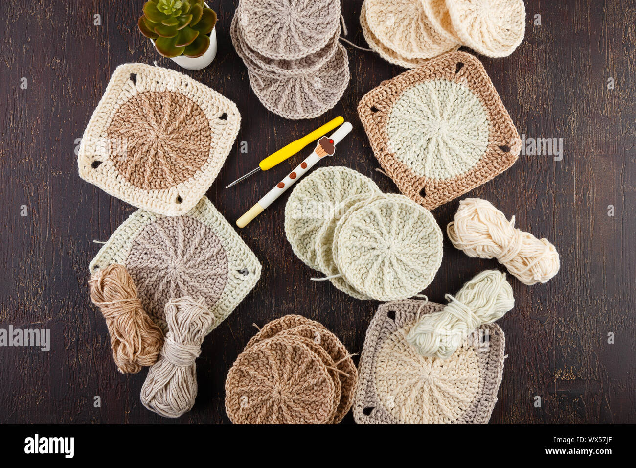 Crochet yarn, crochet hooks, and hand made granny squares. Stock Photo