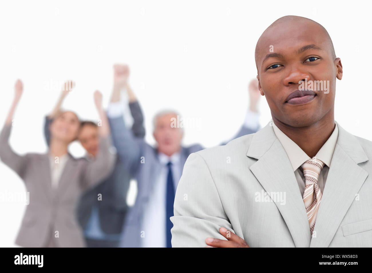Tradesman with cheering team behind him against a white background ...