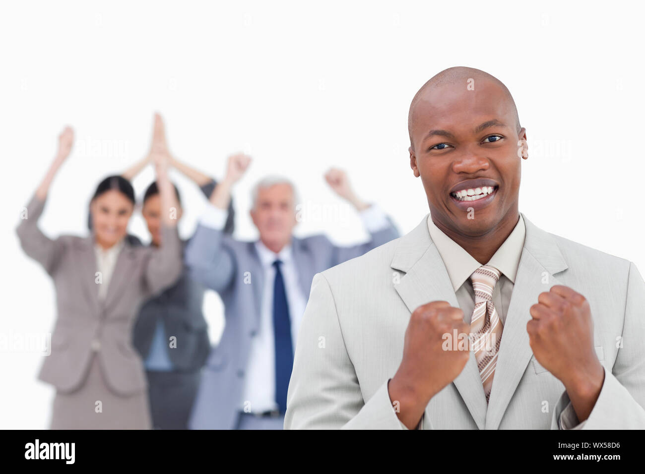 Successful businessman with cheering team behind him against a white ...