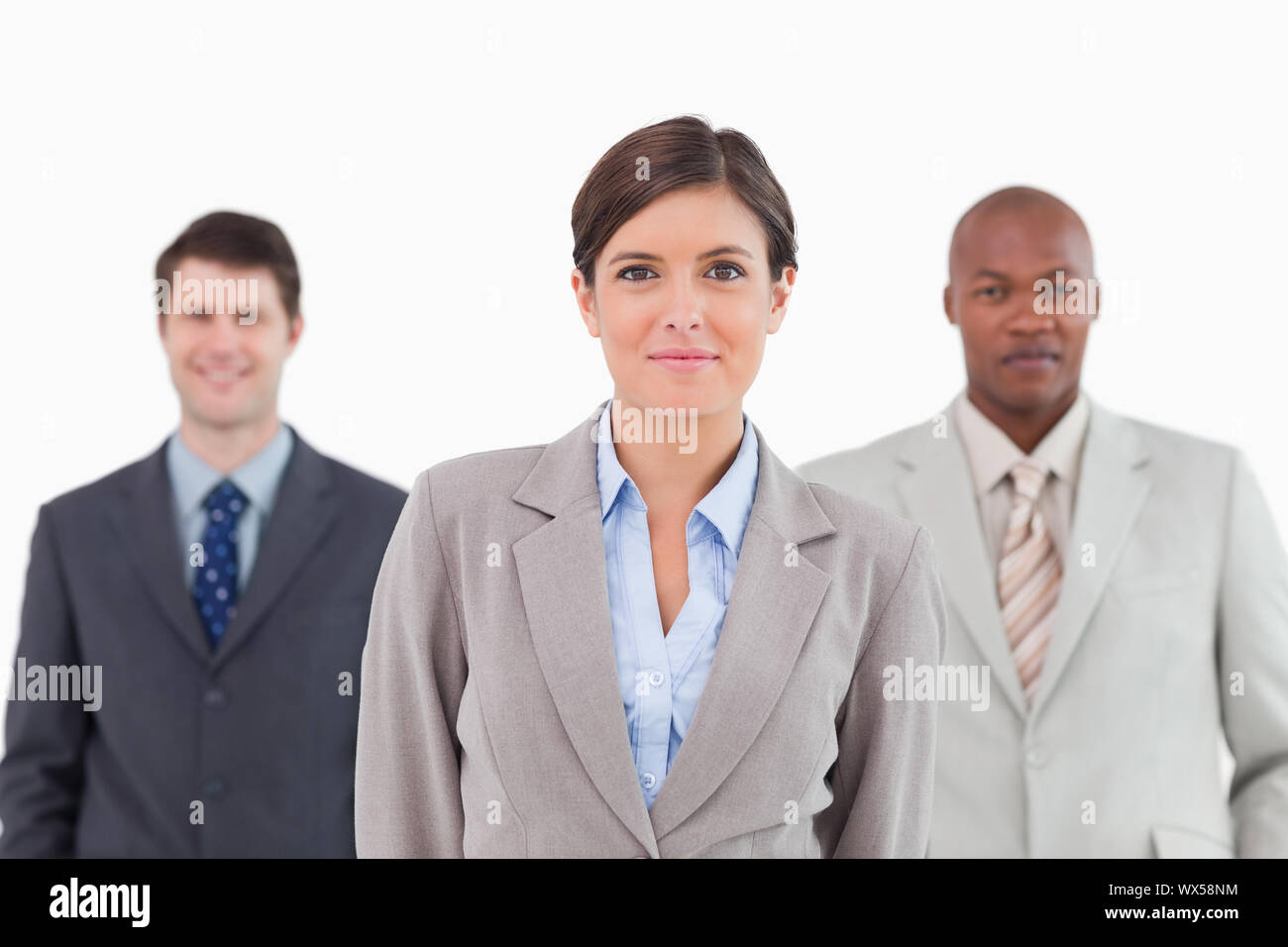 Three businesspeople standing together against a white background Stock Photo