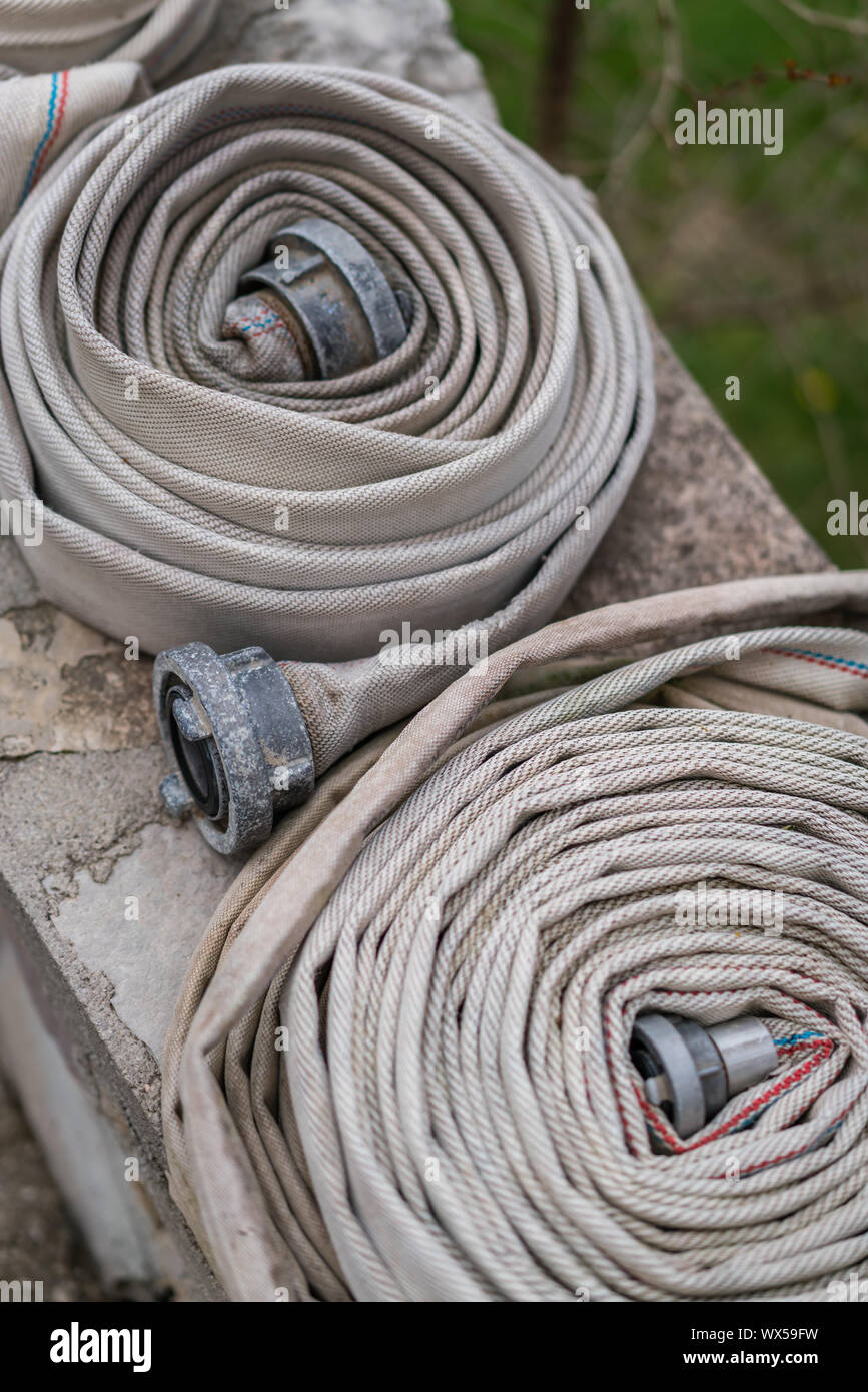 Pile of used folded firefighters water hoses Stock Photo Alamy