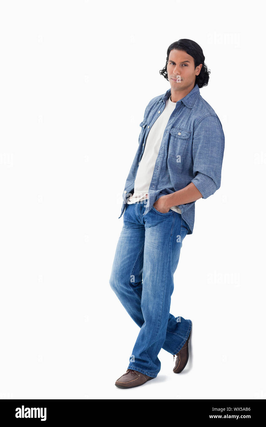 man leaning against a wall with white background Stock Photo - Alamy