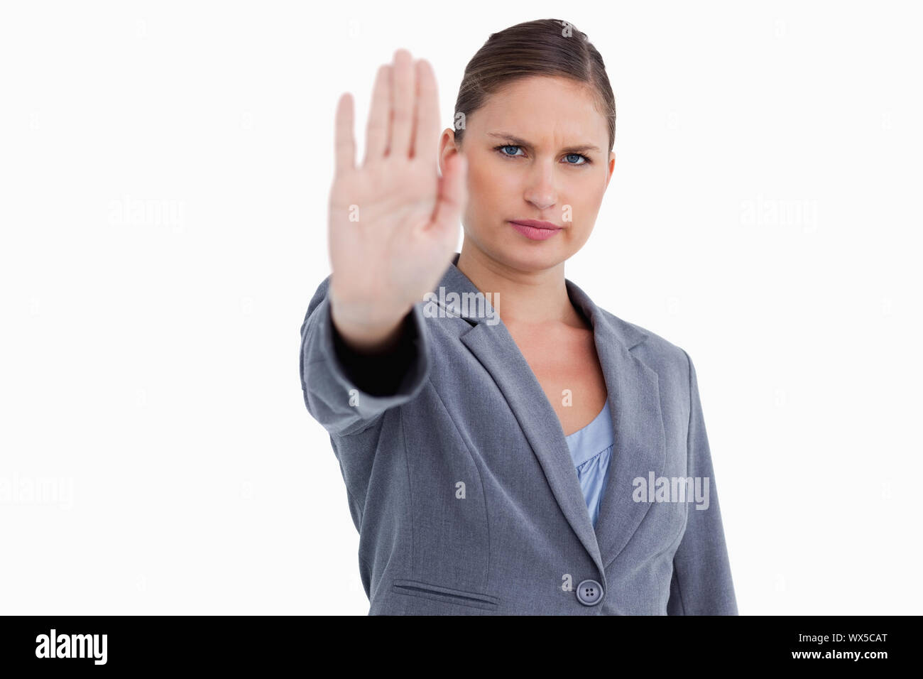 Tradeswoman signalizing stop against a white background Stock Photo