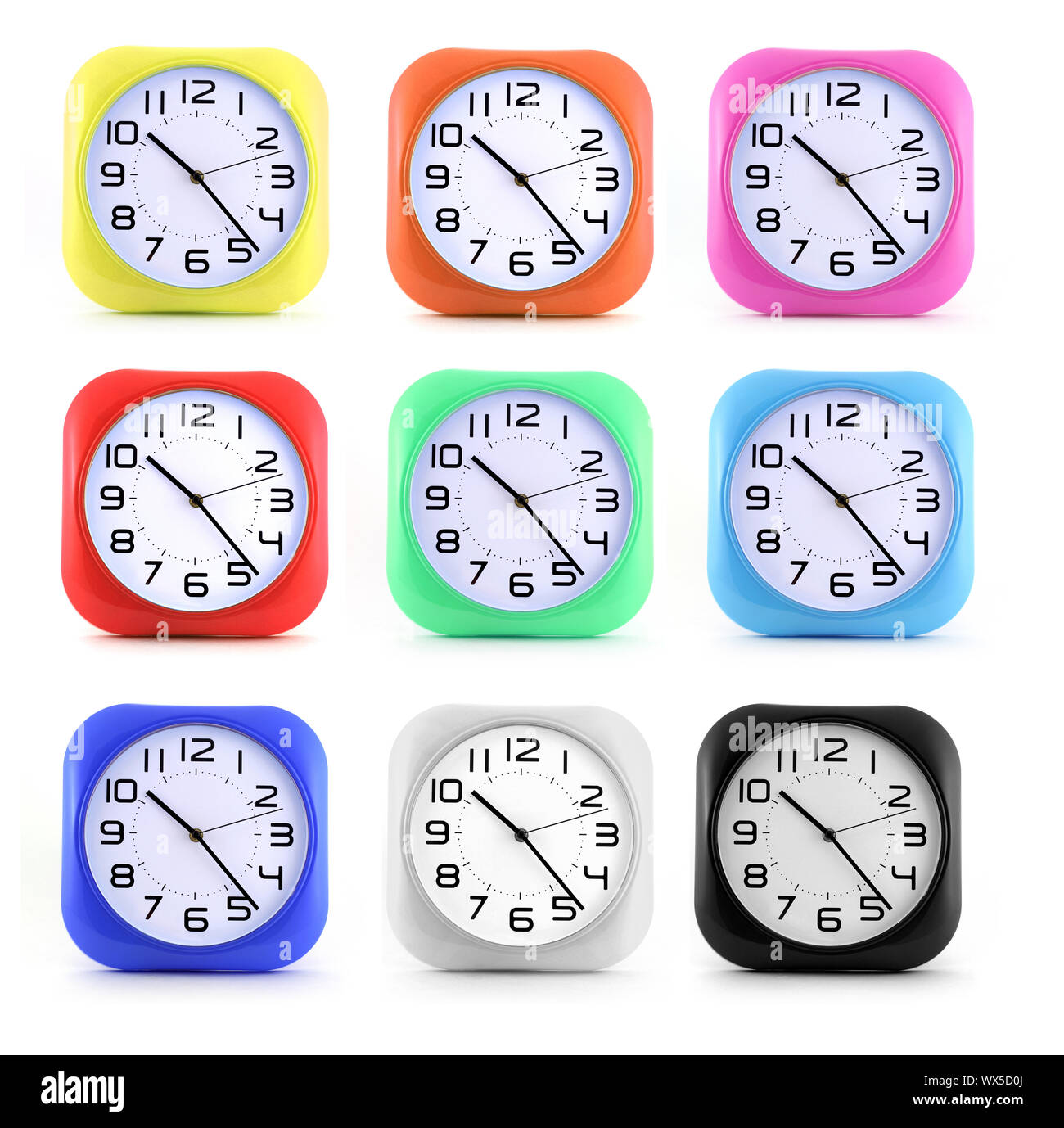Set small alarm clocks in different colors on white background Stock