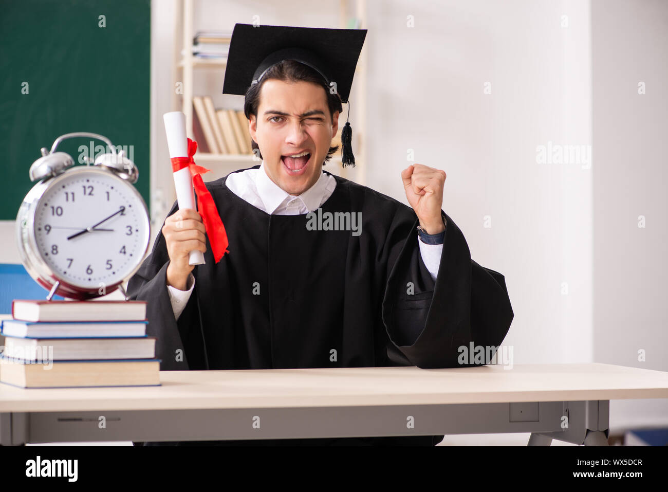 Graduate Board Students Graduate student in front of green board Stock Photo - Alamy