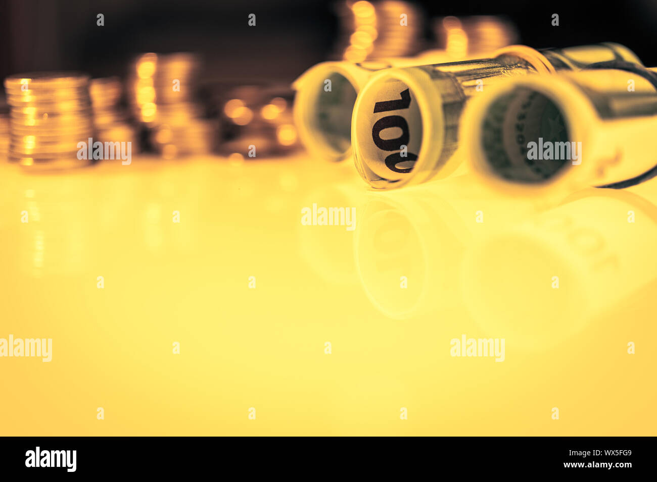 Close up view of stack coins and cash money euros roll bills. Finance and business concept Stock ...