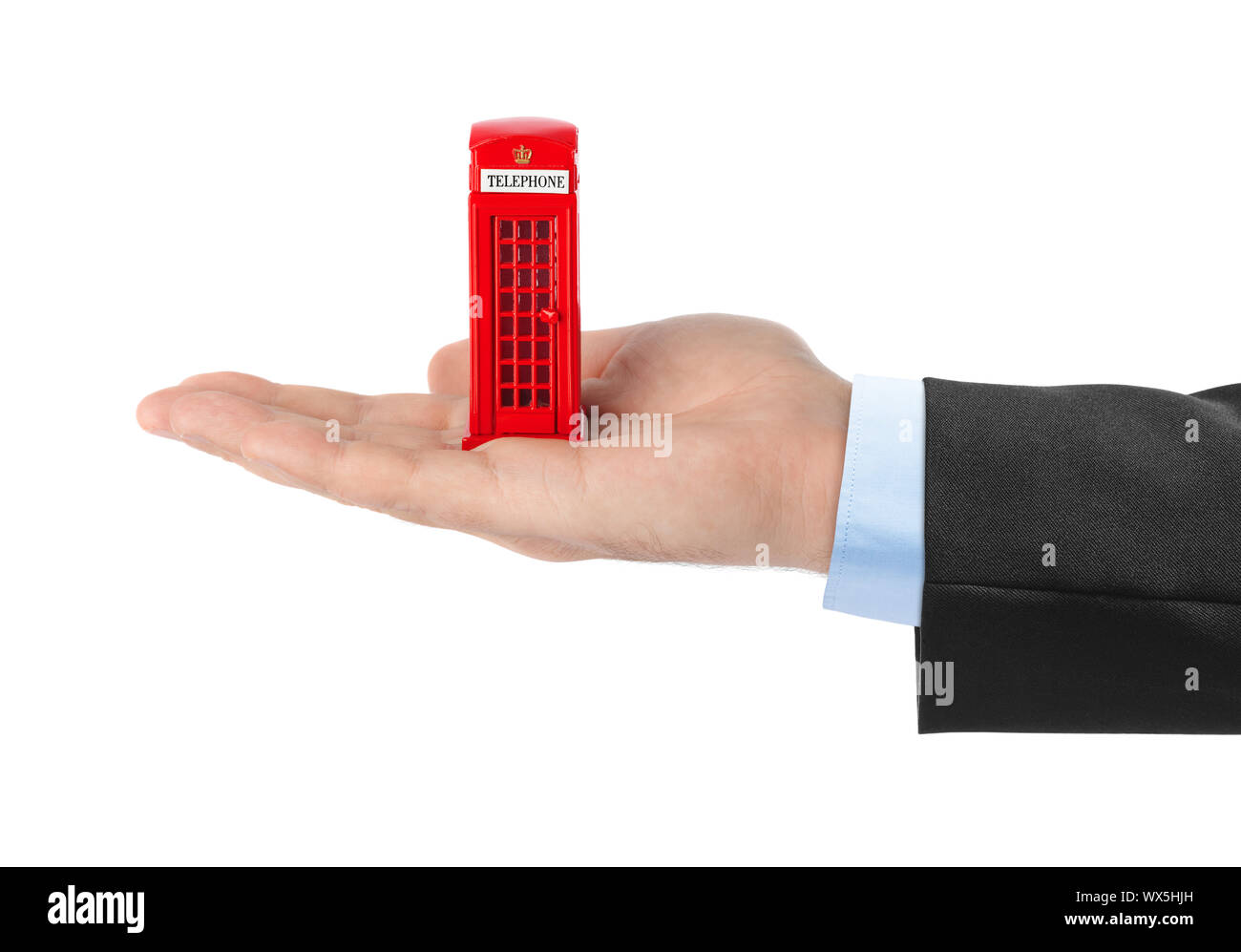 Hand with toy red phone booth of London Stock Photo