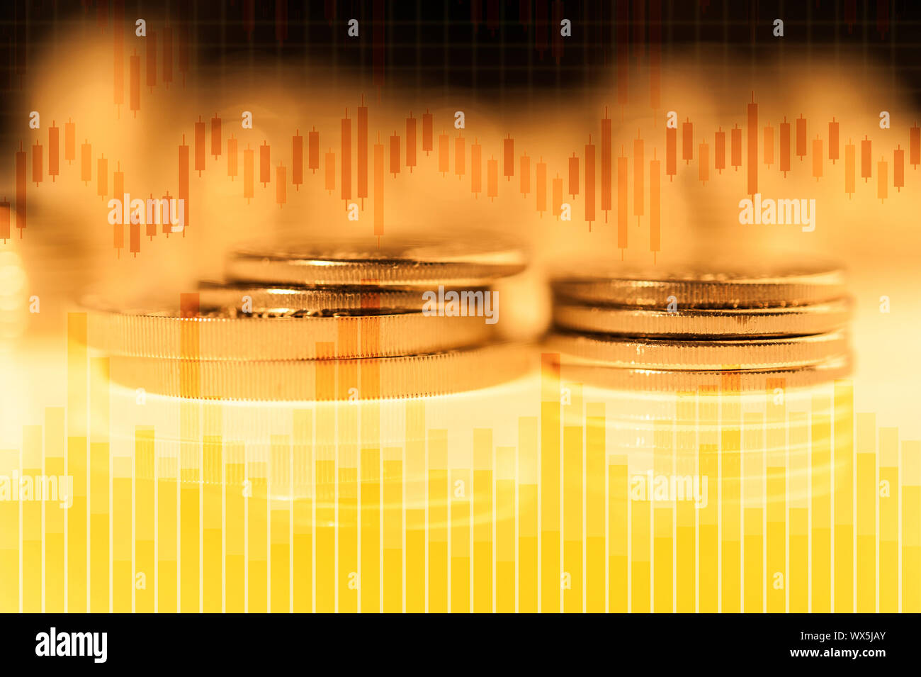 Graph and rows of gold coins for finance and business concept. Trade in precious metals. Stock Photo