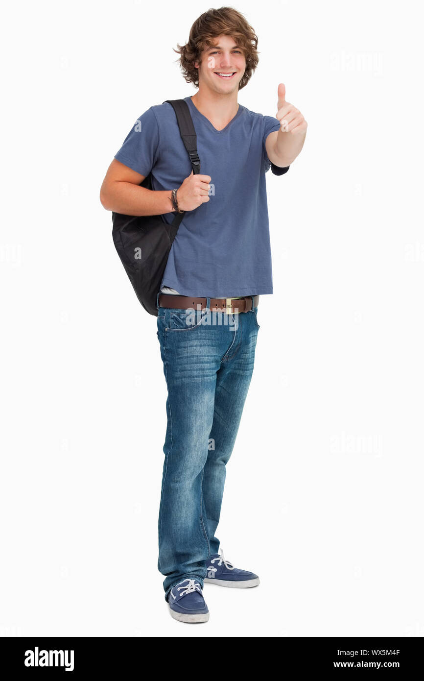 Smiling male student with a backpack the thumb-up against white ...