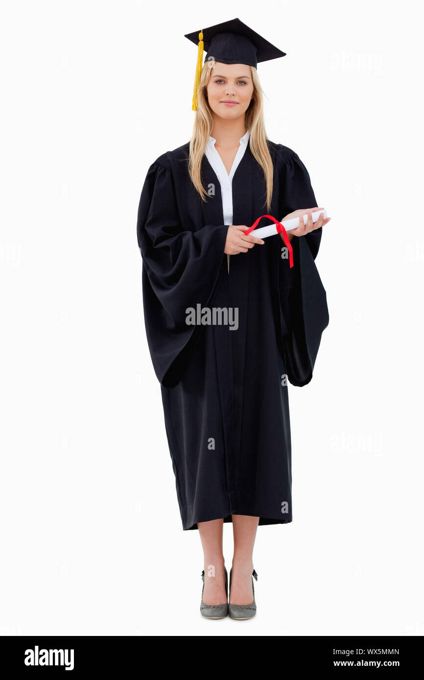 Blonde student in graduate robe holding her diploma against white ...