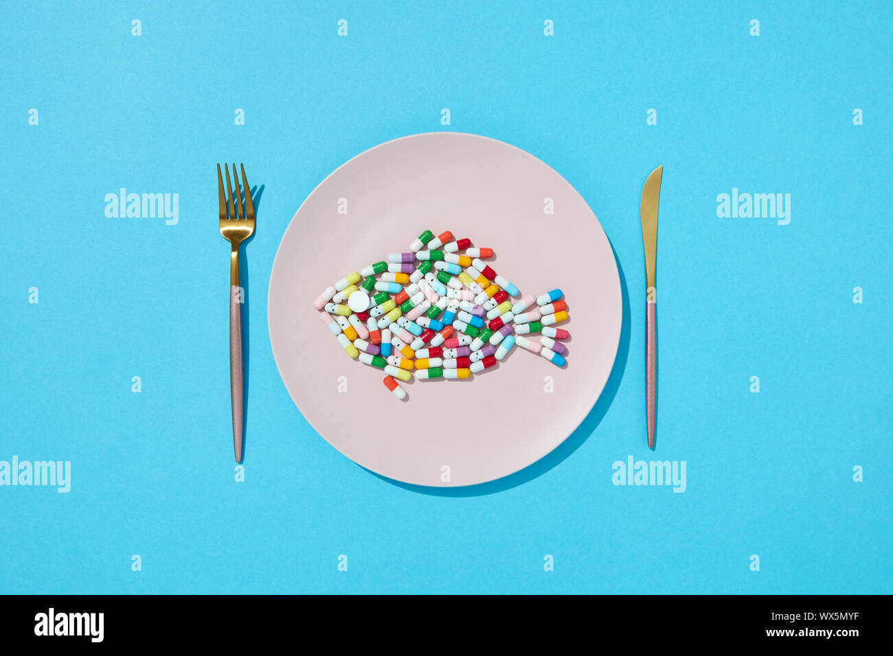Colorful Capsules And Pills In The Form Of Fish On A Plate With