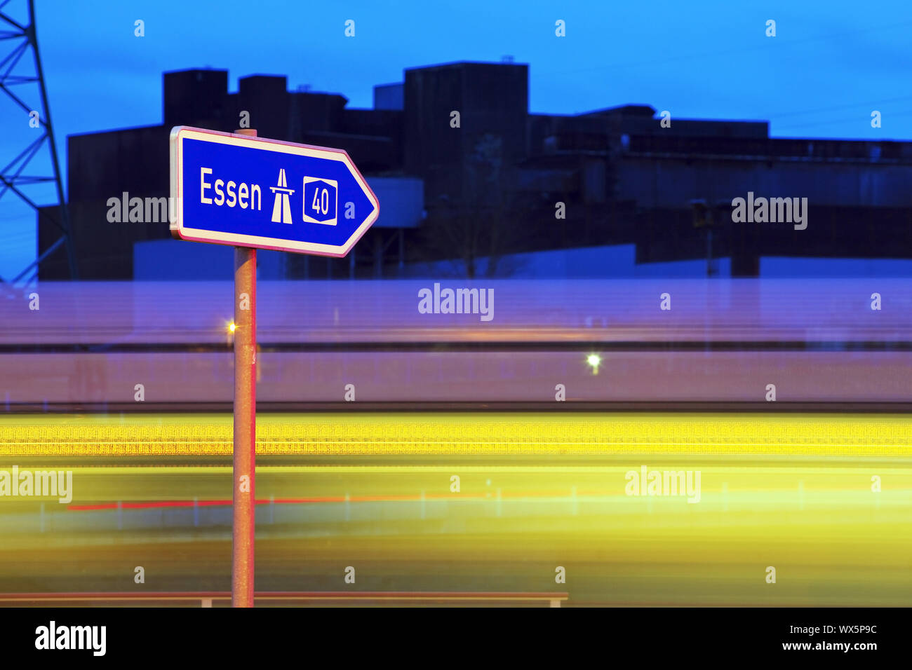 direction sign to Essen on the motorway A40 in the evening, Bochum, Ruhr Area, Germany, Europe Stock Photo