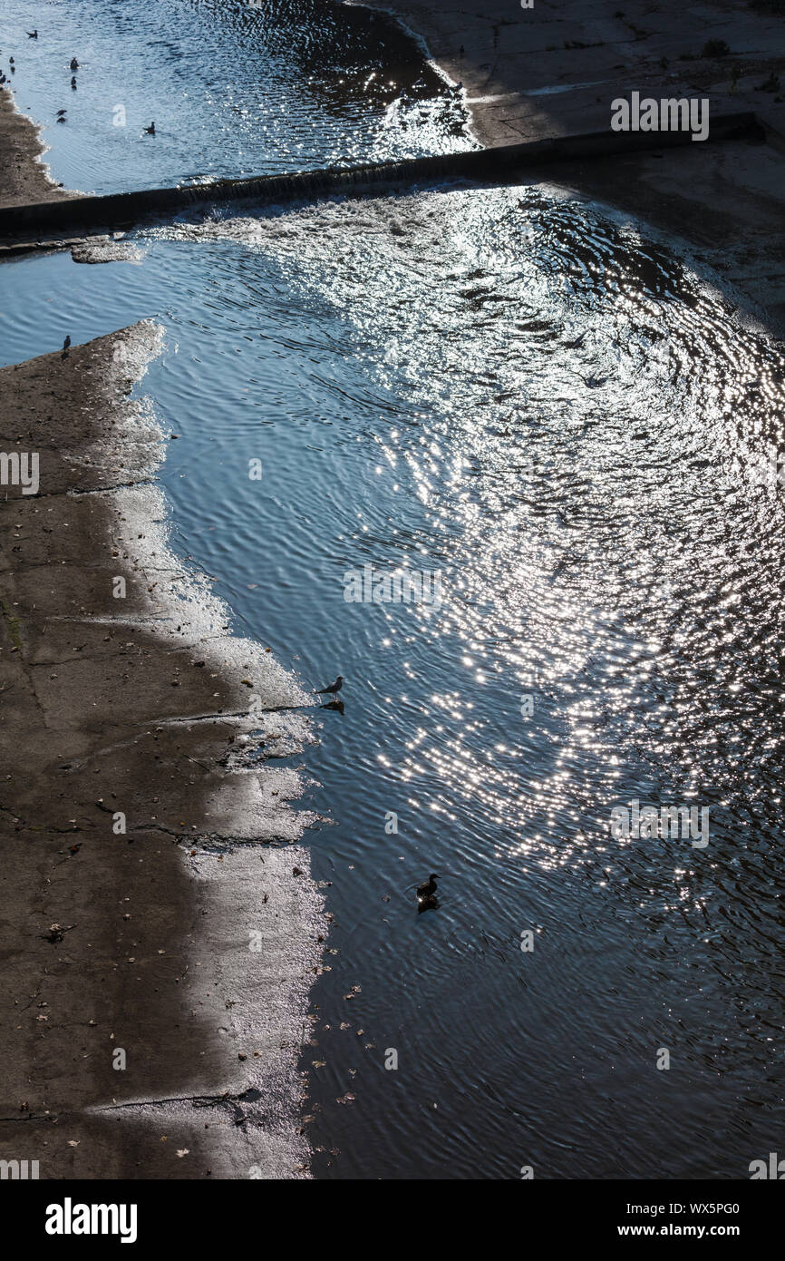 falling sunlight on river in the city Stock Photo