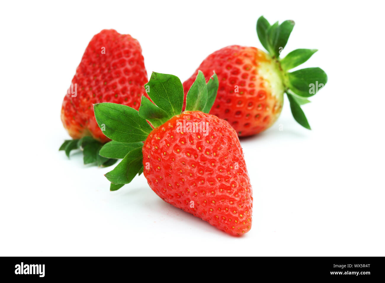 Three fresh strawberries isolated on white background. Stock Photo