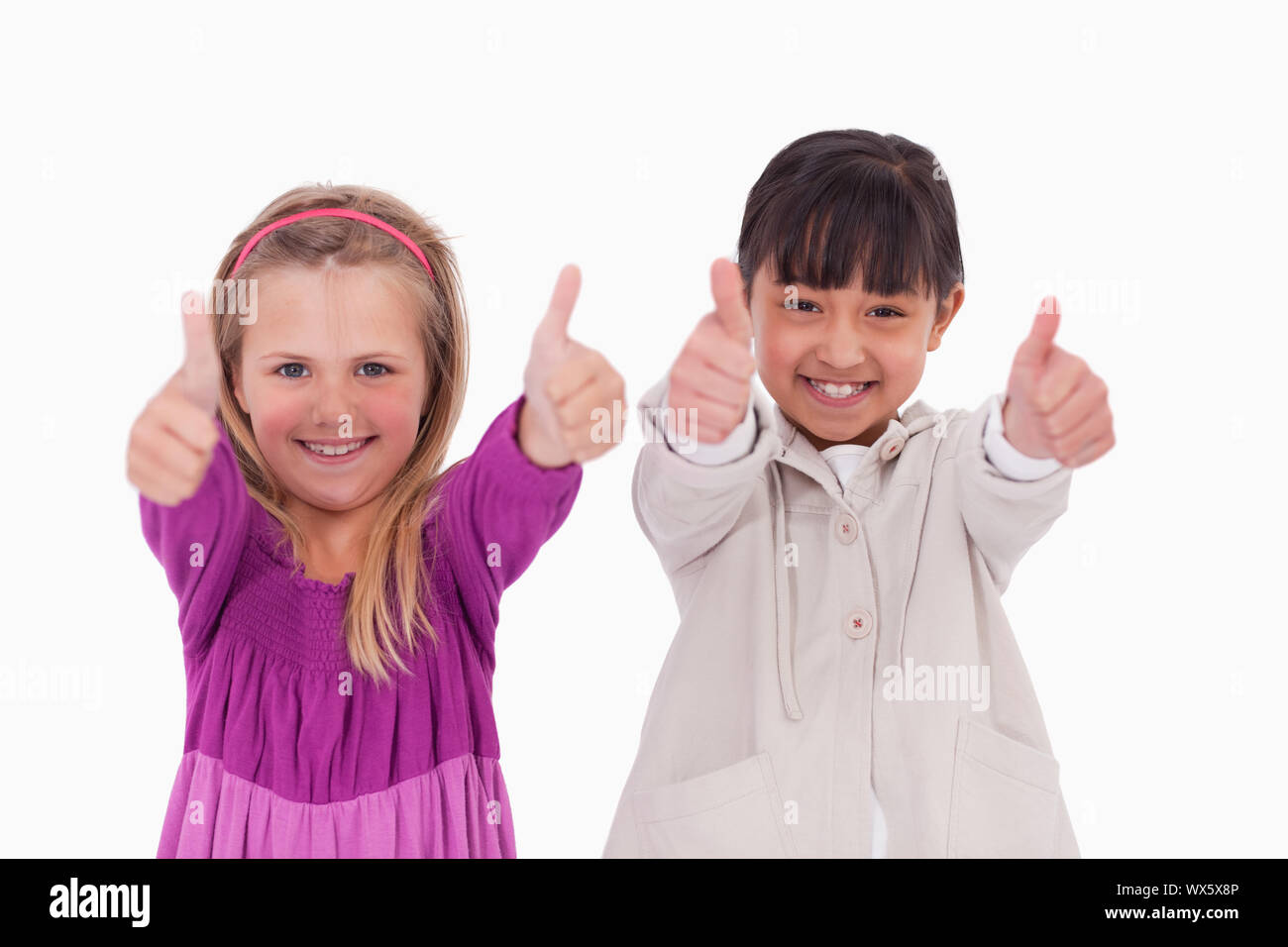 Girls with the thumbs up against a white background Stock Photo - Alamy