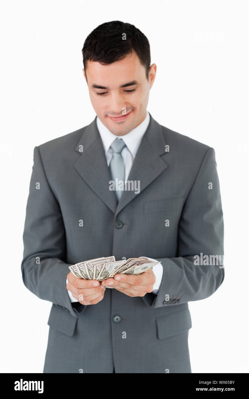 Businessman counting bank notes against a white background Stock Photo ...