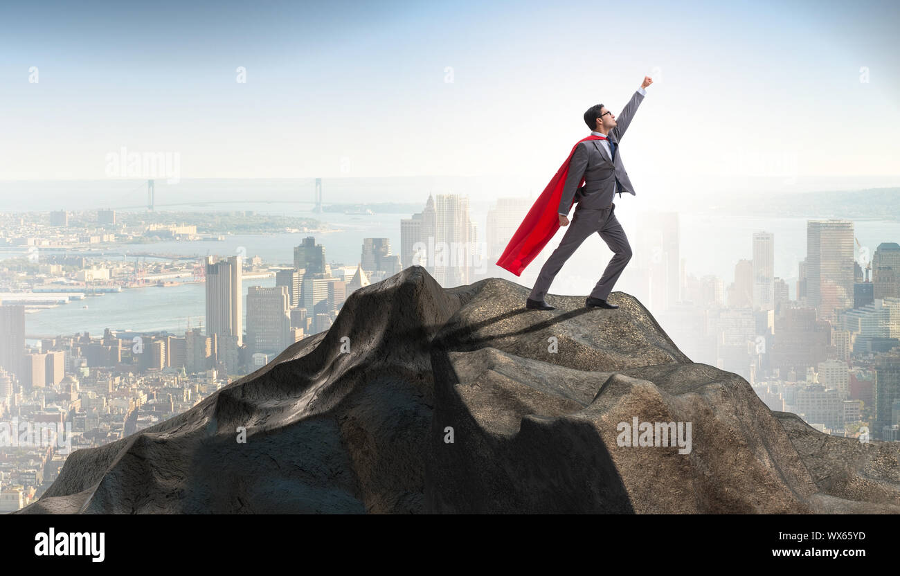Superhero businessman on top of mountain Stock Photo - Alamy