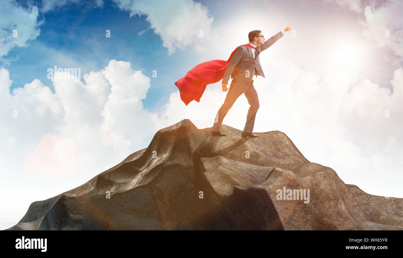 Superhero businessman on top of mountain Stock Photo - Alamy