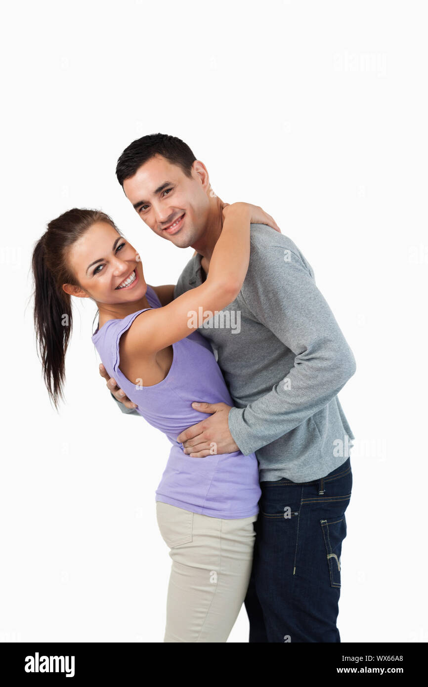 Young couple hugging each other against a white background Stock Photo ...