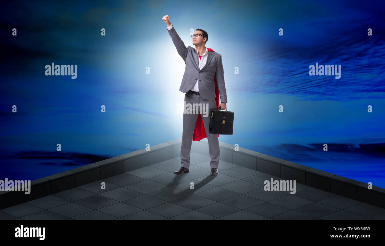 Superhero businessman on top of building Stock Photo - Alamy