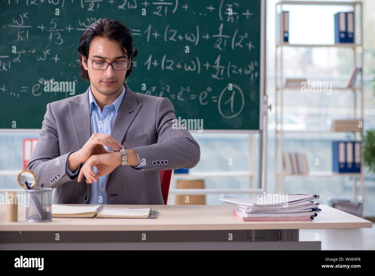 Young handsome math teacher in classroom Stock Photo