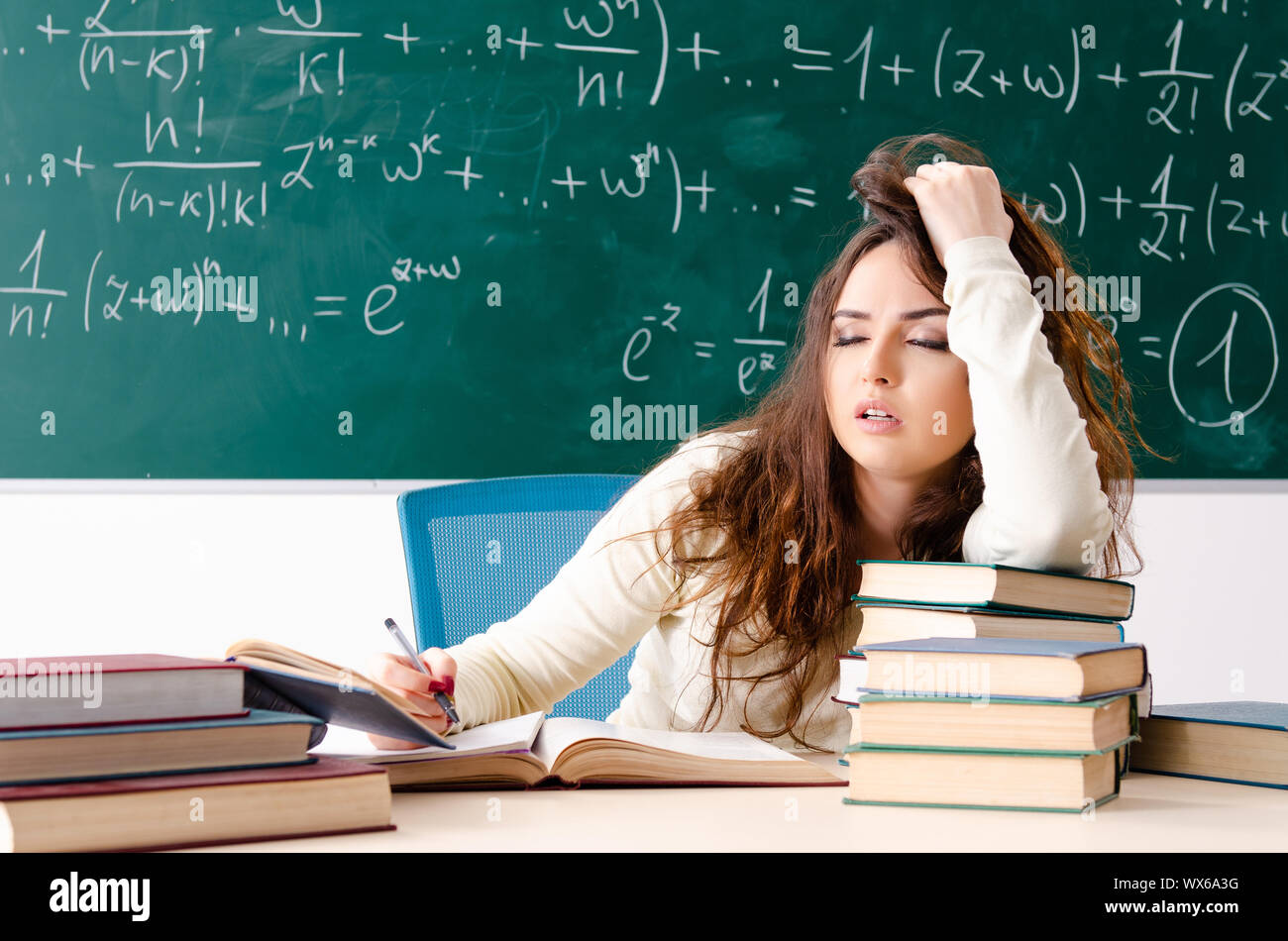 Young female math teacher in front of chalkboard Stock Photo - Alamy